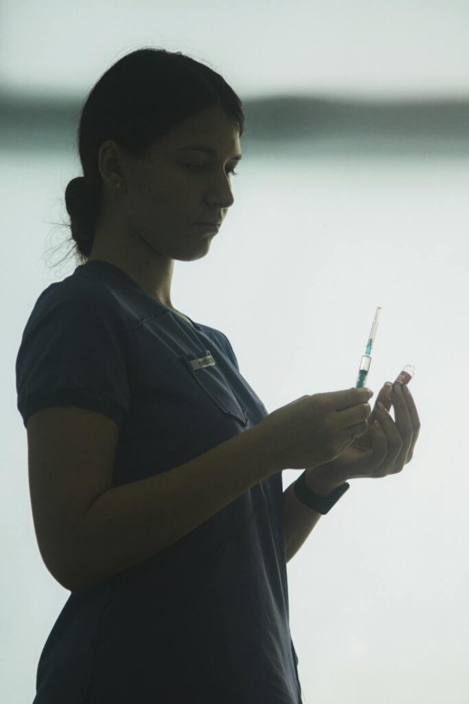 Nurse preparing a Botox injection syringe in a clinic, one of the two options compared in Botox vs MVD surgery for facial nerve disorders