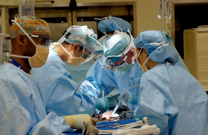 Surgical team performing minimally invasive spine surgery in Faisalabad operating room