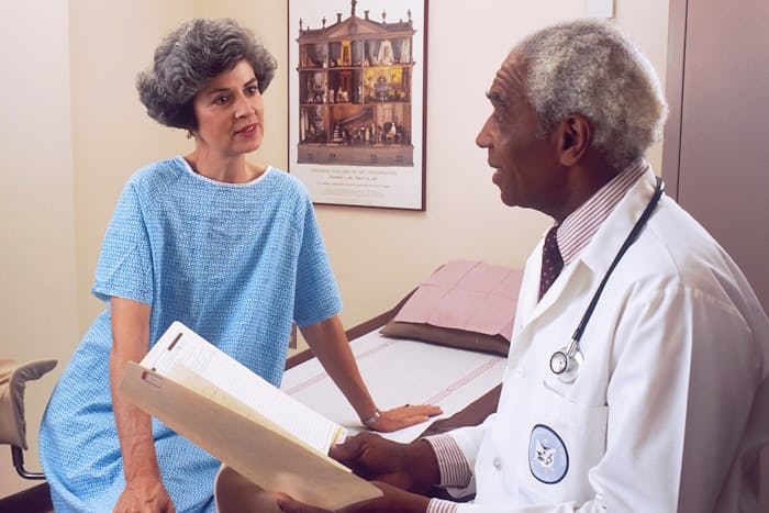 Patient holding medical reports before trigeminal neuralgia treatment consultation in Faisalabad